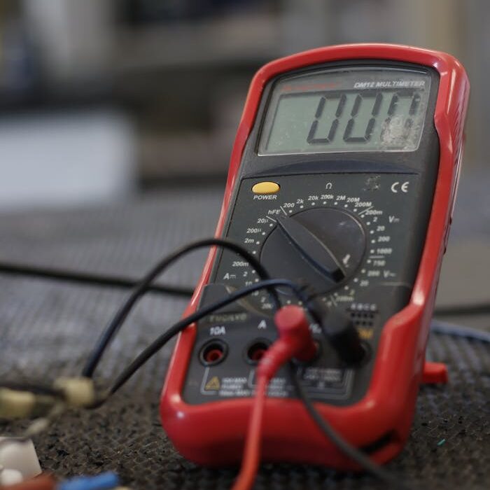 Professional multimeter with wires that combining functions of voltmeter ammeter ohmmeter placed on floor